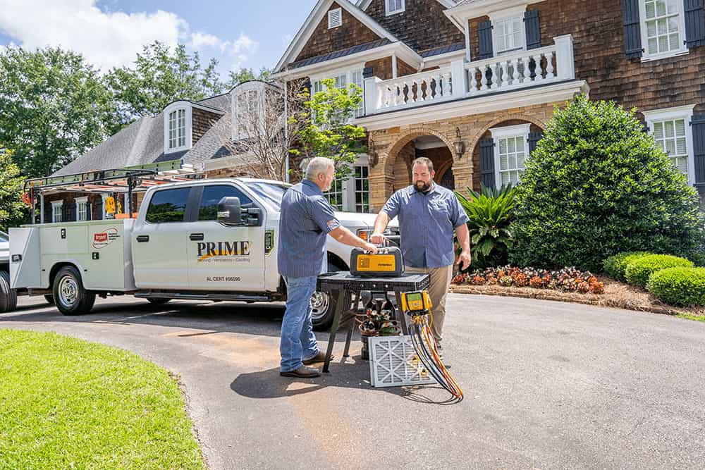 Technicians preparing tools by a service truck