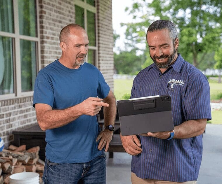 Two men discussing plans on tablet