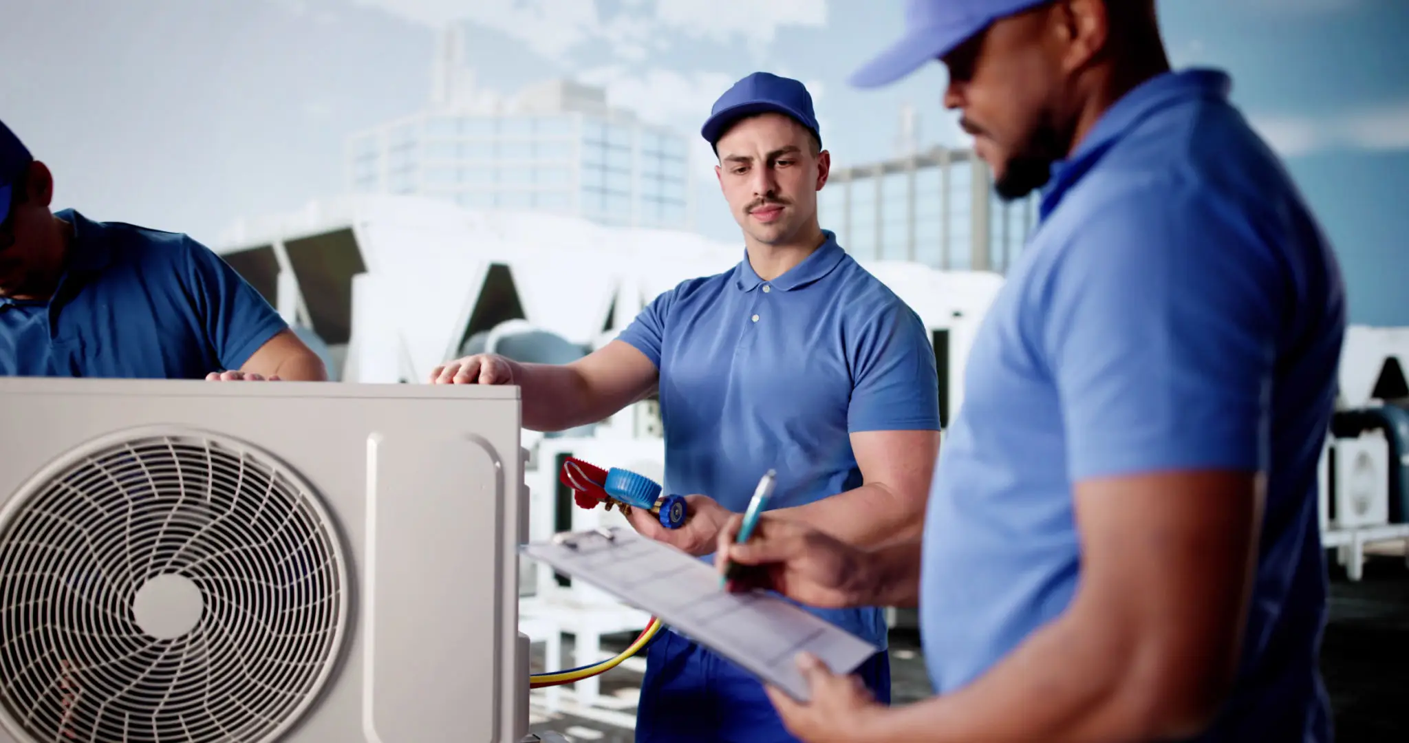 Two HVAC technicians inspecting an air conditioning unit outdoors.