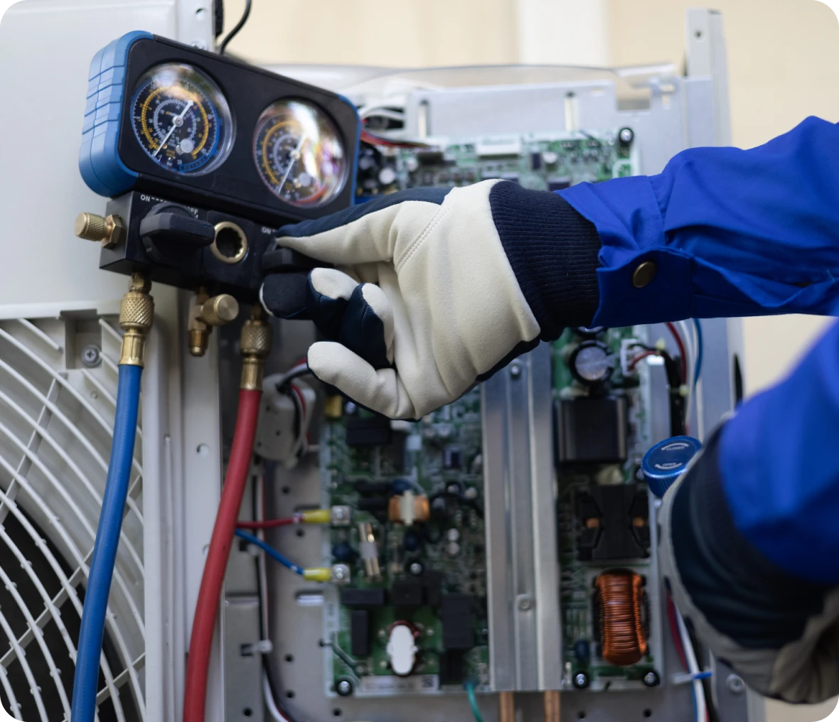 HVAC technician checking system pressure