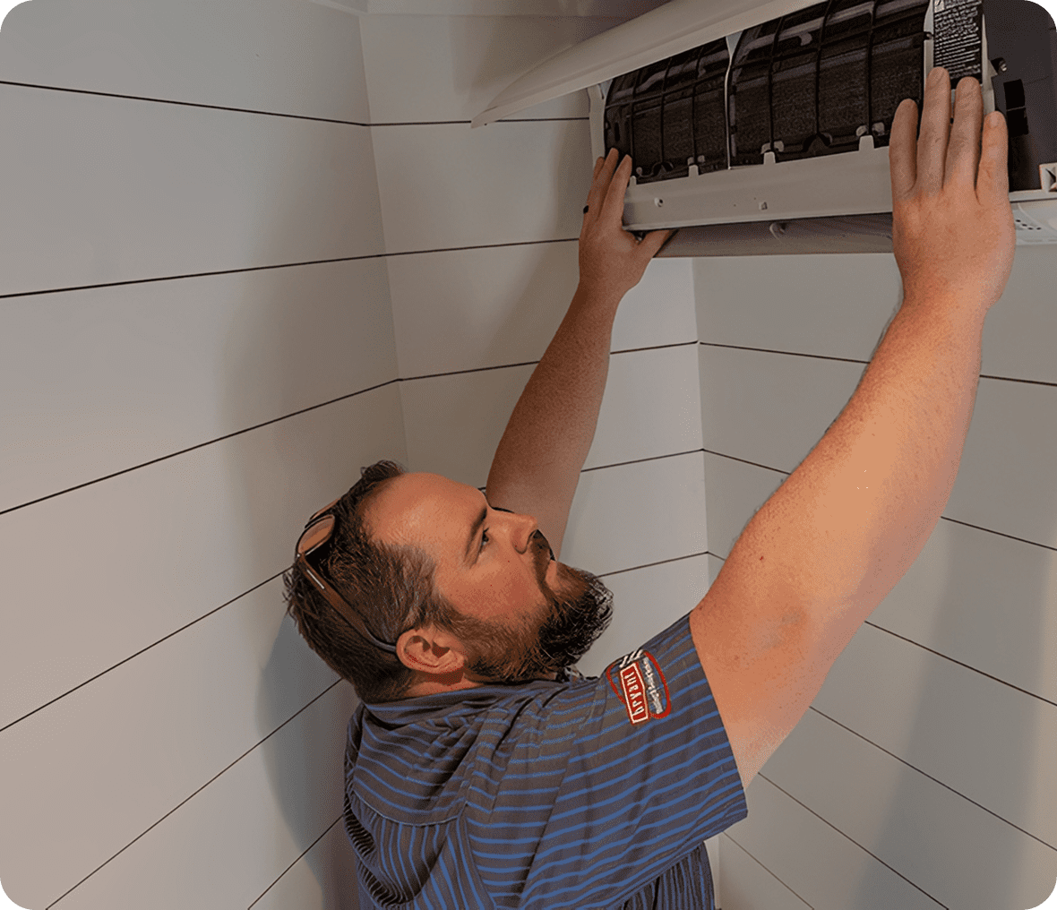 Technician inspecting air conditioning unit
