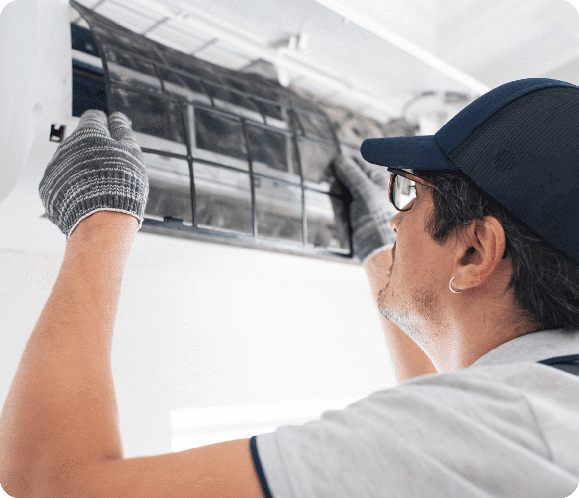Worker servicing home air conditioning system
