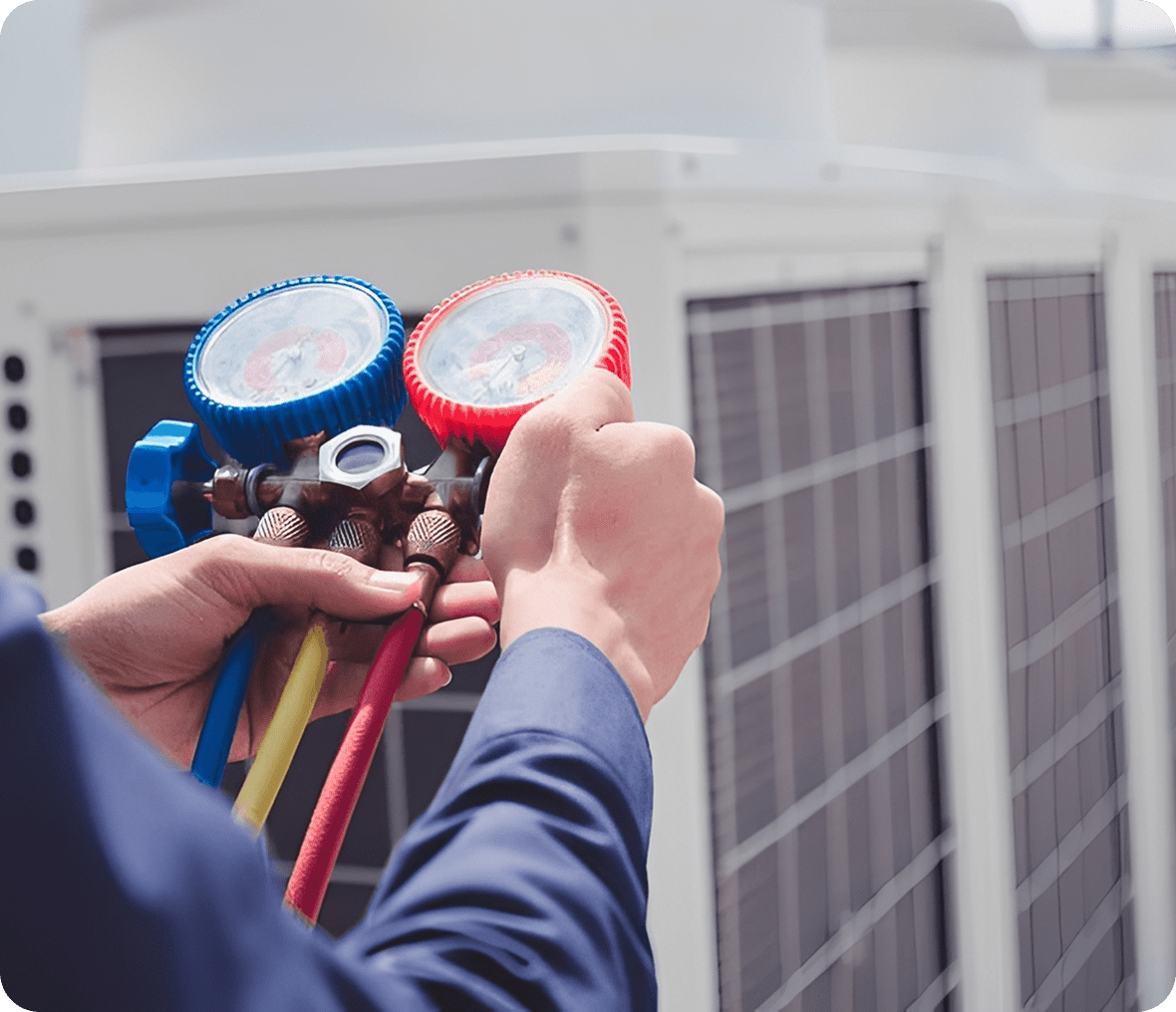 HVAC technician using pressure gauges