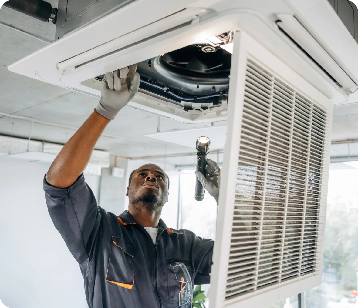 Man repairing office air conditioner system.