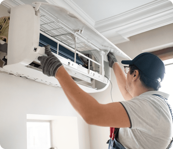 Man fixing AC system indoors