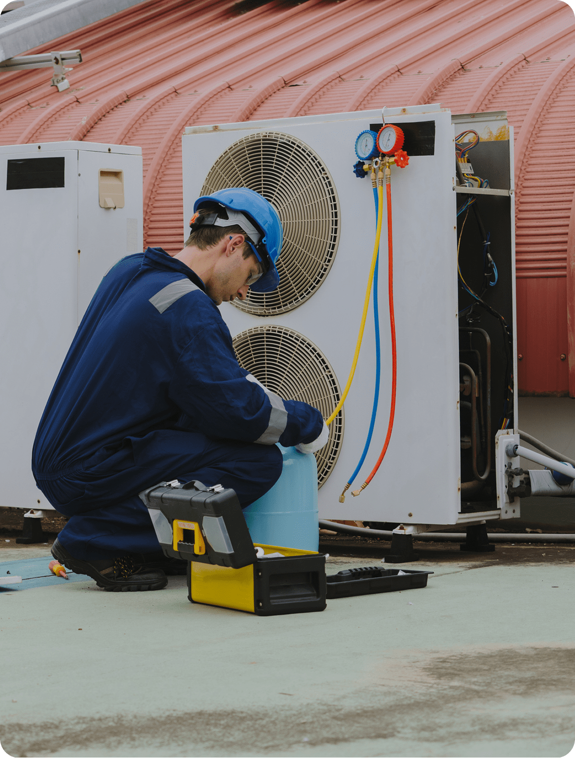 Technician servicing air conditioning unit
